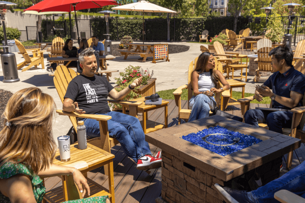 Sony Interactive Entertainment employees eating lunch and talking together in the outdoor courtyard at the corp offices in San Mateo Calif.